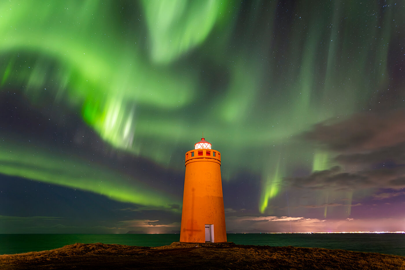Aurora Borealis over Holmsberg Lighthouse, Keflavik, Iceland